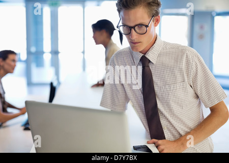 Businessman using laptop at desk Stock Photo