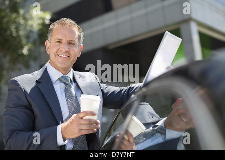 Businessman using tablet computer outdoors Stock Photo