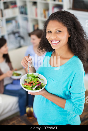 Pregnant woman eating salad Stock Photo