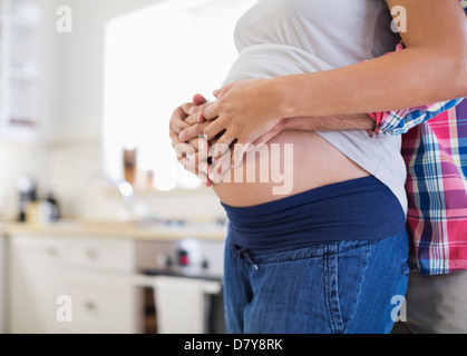 Man holding pregnant girlfriend’s belly Stock Photo