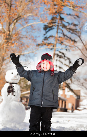 Caucasian boy playing in snow Stock Photo