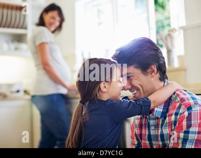 Father and daughter hugging in kitchen Stock Photo