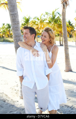 Caucasian couple walking on tropical beach Stock Photo