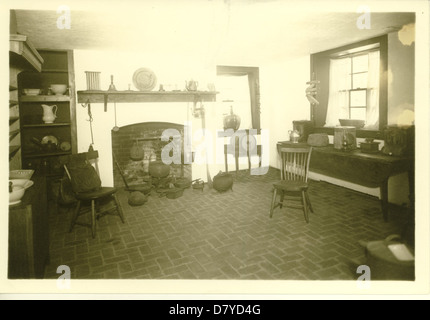 A photograph of a historic kitchen, possibly from the early 20th century. This image captures the typical household setting and provides insight into the daily life and domestic environment of the time. Stock Photo
