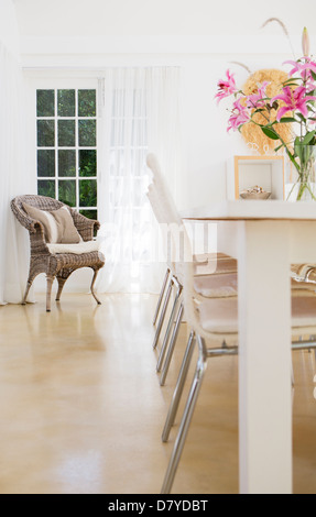 Chairs at table in dining room Stock Photo