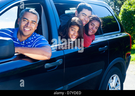 Hispanic family smiling in car