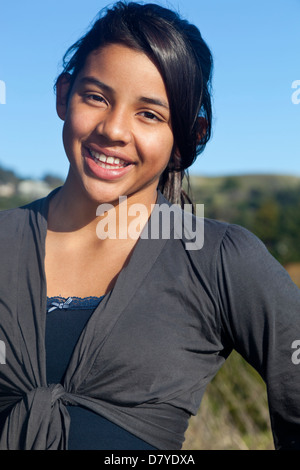 Hispanic teenage girl smiling outdoors Stock Photo