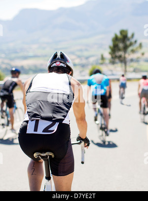 Cyclists in race on rural road Stock Photo