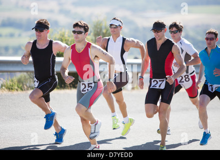 Runners in race on rural road Stock Photo