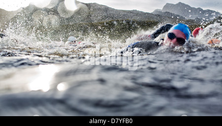 Swimmers splashing in water Stock Photo