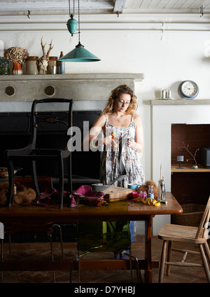 Woman decorating chair with fabric Stock Photo