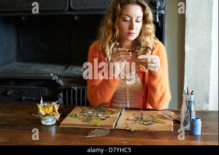Woman decorating dried herbs and flowers Stock Photo