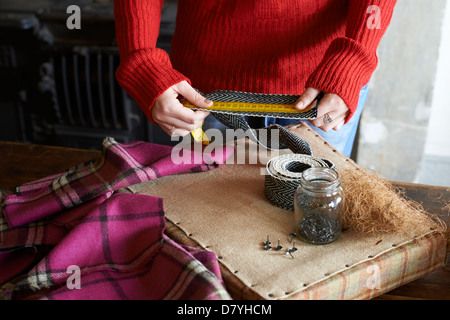 Woman measuring upholstery webbing Stock Photo