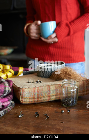 Woman having cup of coffee and crafting Stock Photo