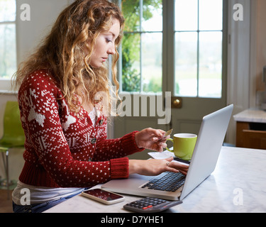 Woman shopping on laptop Stock Photo