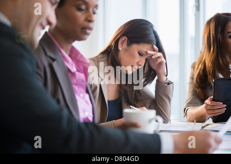 Businesswoman making notes in meeting Stock Photo