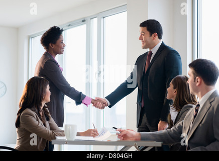 Business people shaking hands in meeting Stock Photo