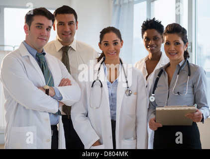 Doctors smiling together in office Stock Photo