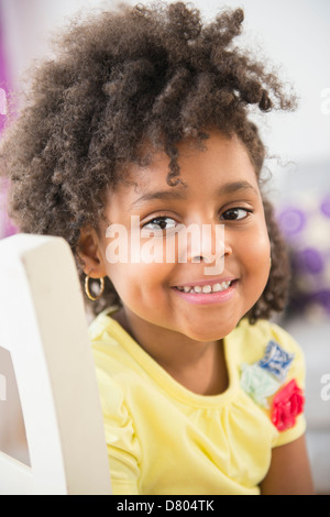 African American girl smiling in chair