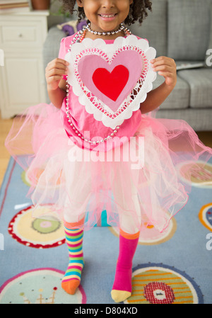 African American girl holding Valentine's Day card Stock Photo