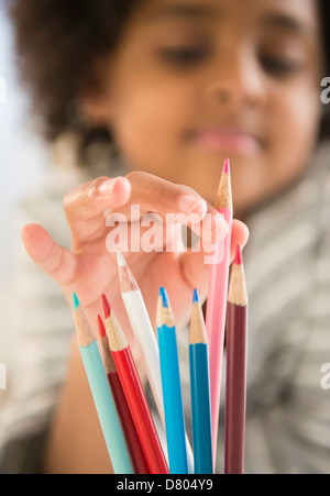 African American girl picking out colored pencil Stock Photo