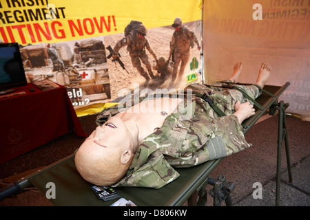 dummy patient on a british army medical regiment recruiting stand at an outdoor event Stock Photo