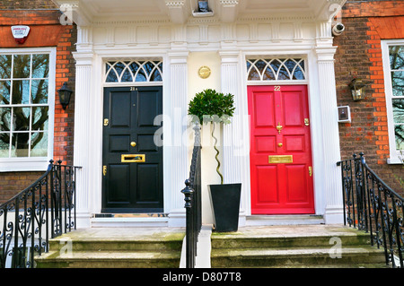 Elegant black and red front doors, Greater London, England, UK Stock Photo