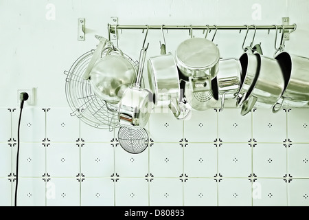 Pots and pans hanging in kitchen Stock Photo