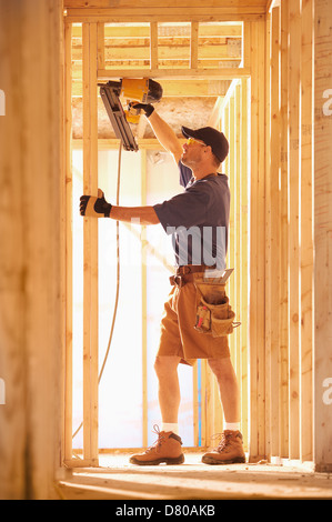 Caucasian carpenter working on building Stock Photo