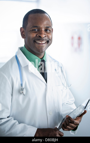 African American doctor smiling in office Stock Photo