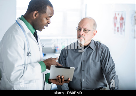 African American doctor talking to patient in office