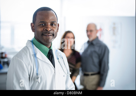 Doctor and patients standing in office