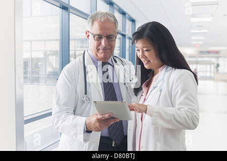 Doctors using tablet computer in hospital Stock Photo