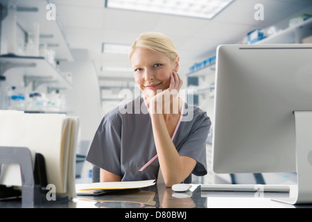 Caucasian nurse working at computer in hospital Stock Photo