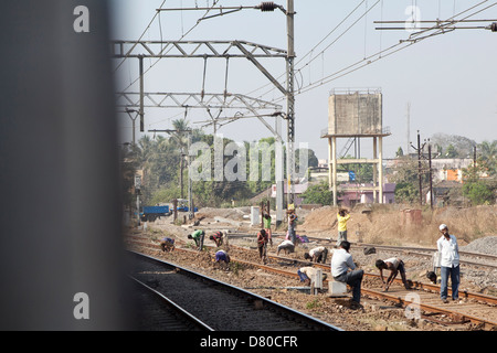 Men working on a train track in India Stock Photo