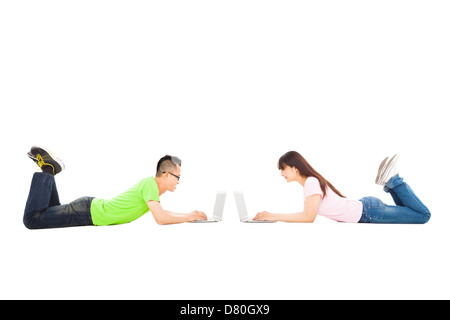 happy young couple lying together with laptop Stock Photo