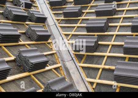 Roof tiles ready to attach to newly built house. Stock Photo