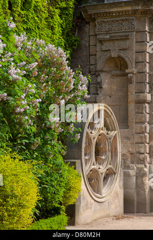 Ancient Stained Glass Window frame on display in the garden at Hotel de Sully, les Marais, Paris France Stock Photo