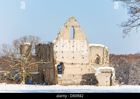 Newark Priory - ruins of a monastery dissolved by Henry VIII - under blue sky in sunshine in the snow - Pyrford, Surrey, England Stock Photo
