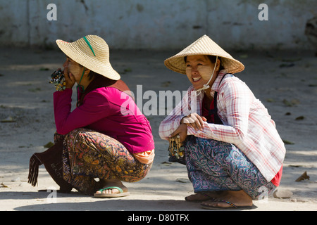 Two girls squatting in the road at Mingun, Myanmar 2 Stock Photo
