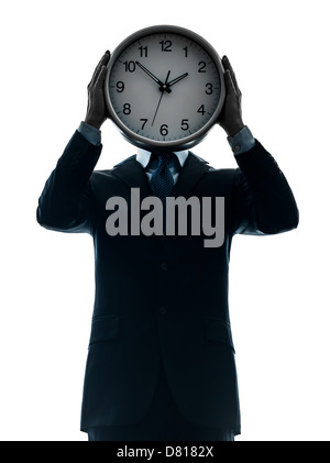 one  businessman holding clock in silhouette studio isolated on white background Stock Photo