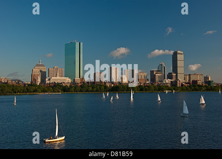 Sailboats seen on the Charles River illuminated by the afternoon sun with the Boston skyline in the background Stock Photo