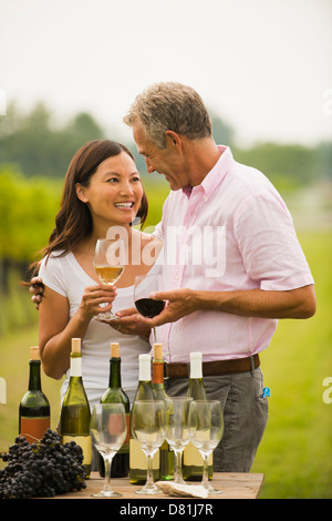 Couple tasting wine together outdoors Stock Photo