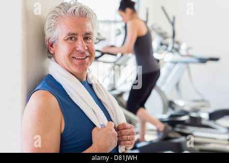 Older Hispanic man smiling in gym Stock Photo