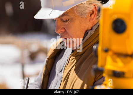 Hispanic surveyor working outdoors Stock Photo