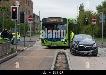 Longstanton, UK. 17th May 2013.An accident between a guided bus and a car at the junction of the busway and the road at Longstanton near Cambridge UK 17th May 2013. Police and officials are investigating the scene. The guided busway is the longest in the world and runs between St Ives and Cambridge. The buses use small wheels mounted on their sides to guide them whilst on the concrete busway and then are driven normally when on roads. Traffic lights control the junction where roads cross the busway. The busway opened in August 2011. Credit Julian Eales Credit: Julian Eales /Alamy Live News Stock Photo