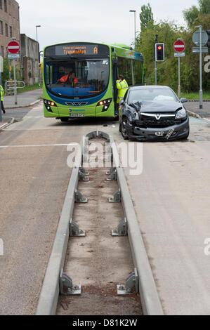 Longstanton, UK. 17th May 2013.An accident between a guided bus and a car at the junction of the busway and the road at Longstanton near Cambridge UK 17th May 2013. Police and officials are investigating the scene. The guided busway is the longest in the world and runs between St Ives and Cambridge. The buses use small wheels mounted on their sides to guide them whilst on the concrete busway and then are driven normally when on roads. Traffic lights control the junction where roads cross the busway. The busway opened in August 2011. Credit Julian Eales Credit: Julian Eales /Alamy Live News Stock Photo