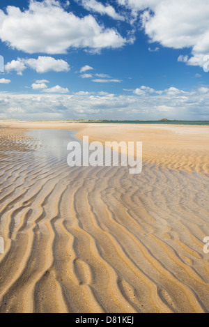 Ripples in the sand on the beach at Ross Sands pointing to Lindisfarne Castle on the Northumbrian coast, Northumberland, England