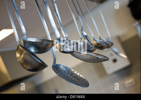 Rack of kitchen utensils hanging Stock Photo