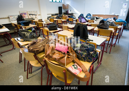 Empty classroom with schoolbags on the tables Stock Photo